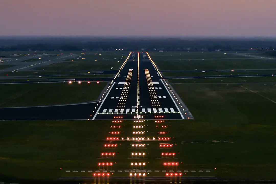 Airport runway at dusk with illuminated light - Runway Lights Explained | Colors, Spacing, Types - Vorlane - Vorlane