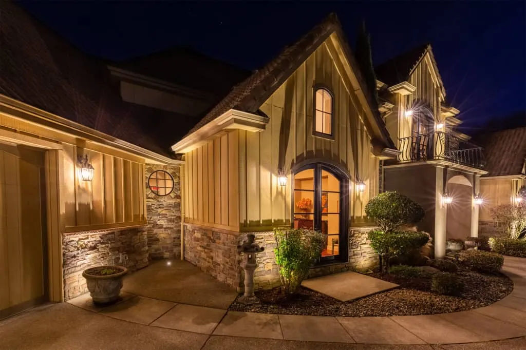An elegant house at night illuminated by well placed exterior lights highlighting architectural details and landscaping - Enhance Your Home with Effective Front of House Lighting Positions - Vorlane - Vorlane